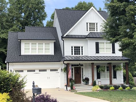 painted brick house with metal roof|white house black metal roof.